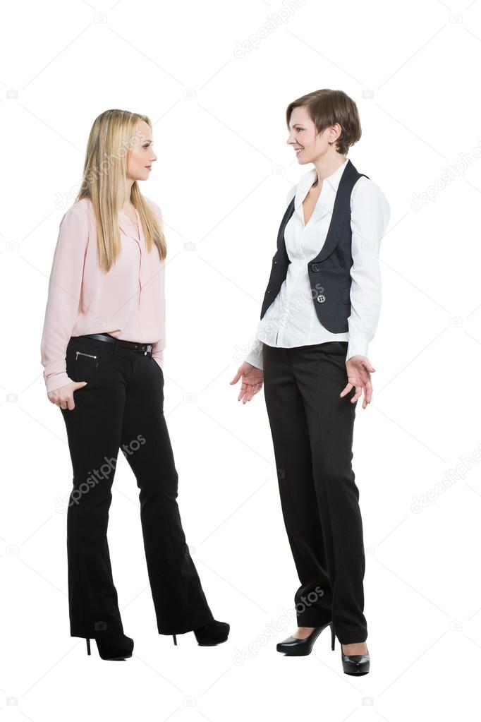 two businesswomen, isolated on white background. body language, gestures psychology. paired gestures. Pose justification. The woman obeys boss.