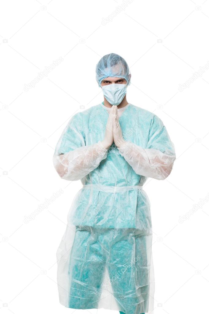 Surgeon portrait. isolated on white background. focuses on reflection. fingers pyramid. praying