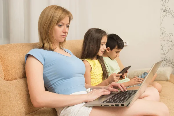 Mother, daughter, son with laptop and tablet pc. Internet addiction. — Stock Photo, Image