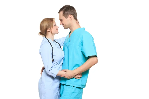 A male and a female doctor kissing at work. love affair at work. isolated on white background — Stockfoto