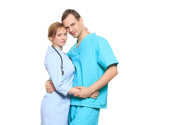 A male and a female doctor kissing at work. love affair at work. isolated on white background — Stockfoto