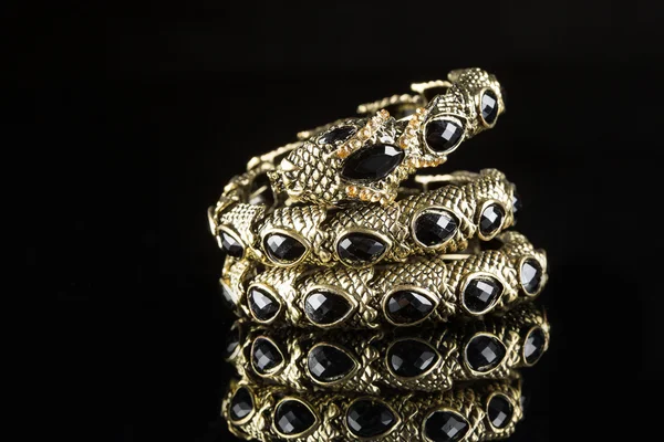 Golden bracelet form of snake isolated black background — Stock Photo, Image