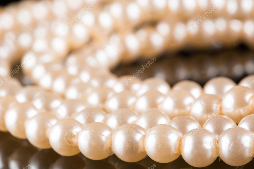 White pearls on  black  background. luxury necklace.