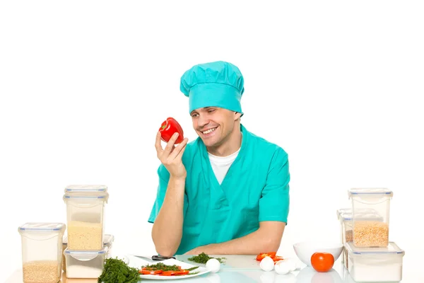 Friendly chef preparing vegetables in his kitchen. pepper loves — Stock Photo, Image