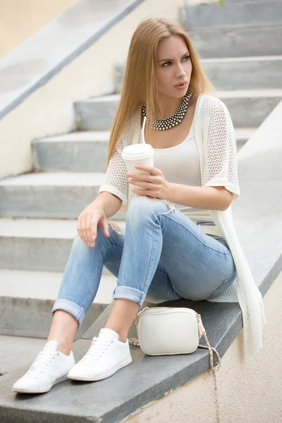 Stylish woman drinking coffee to go in a city street — Stock Photo, Image