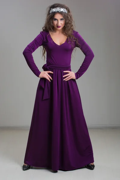 Όμορφη μόδας μοντέλο που θέτουν σε βραδινό φόρεμα και το διάδημα πάνω από σκούρο φόντο. — Φωτογραφία Αρχείου