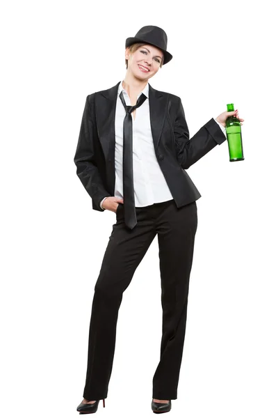 Happy elegant woman in a business suit, holding bottle of alcohol. Isolated on white background — Stock Photo, Image