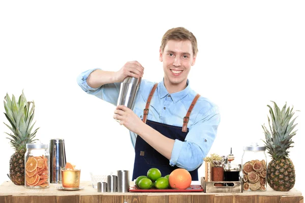 Bartender with a shaker and bottle on white background. behind the bar — Stock Photo, Image