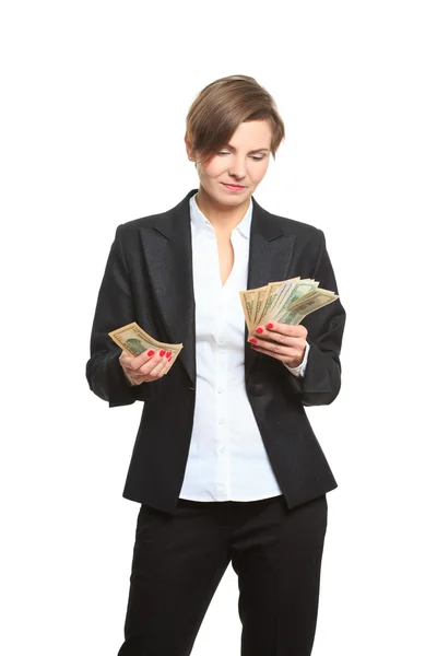Mladý veselá kavkazské podnikatelka v černém obleku drží peníze, izolované na bílém — Stock fotografie