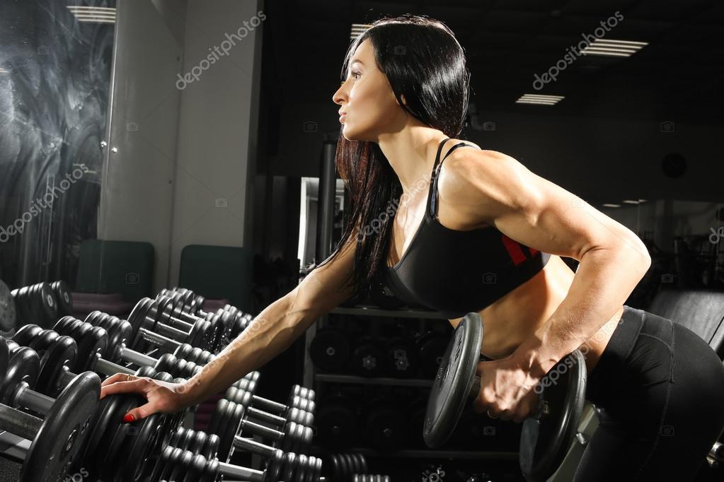 Premium Photo  Beautiful sexy athletic young caucasian girl working out in gym  training chest. pumping up pectoral muscles with dumbbells