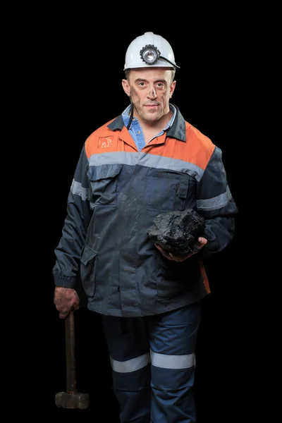Coalminer holds out a large chunk of energy rich coal — стоковое фото