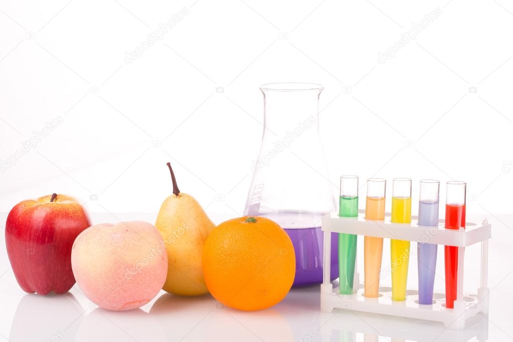 Fruit close chemical test tubes. Genetic Engineering. pesticides in foods