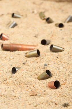 cartridge cases on the sand. clipart