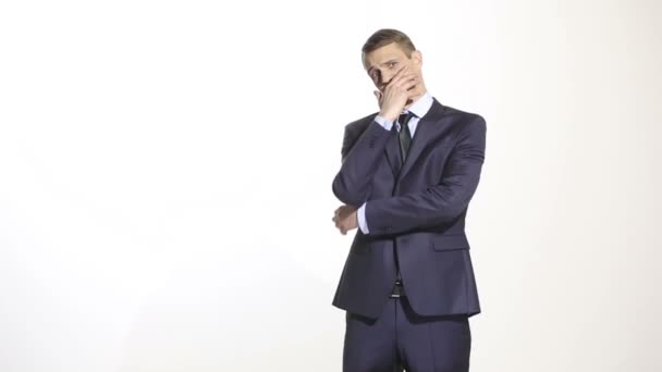 Gestures distrust lies. body language. man in business suit isolated on white background. closed position. closes mouth by hand. his arms — Stock Video