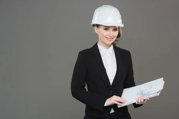 Woman architect with drawings. Beautiful girl in a building helmet — Stock Photo, Image