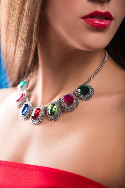 Necklace on the neck. ruby and emerald — Stock Photo, Image