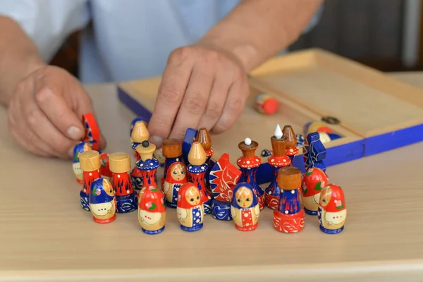 Board game of chess during self-isolation, close-up of bright matryoshka figures