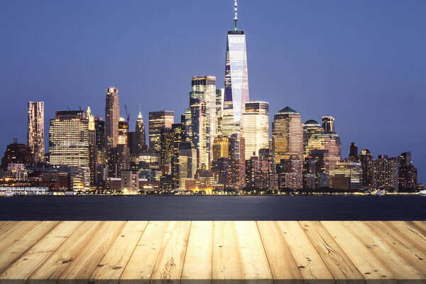 Table top made of wooden dies with beautiful Manhattan cityscape at twilight on background, mockup