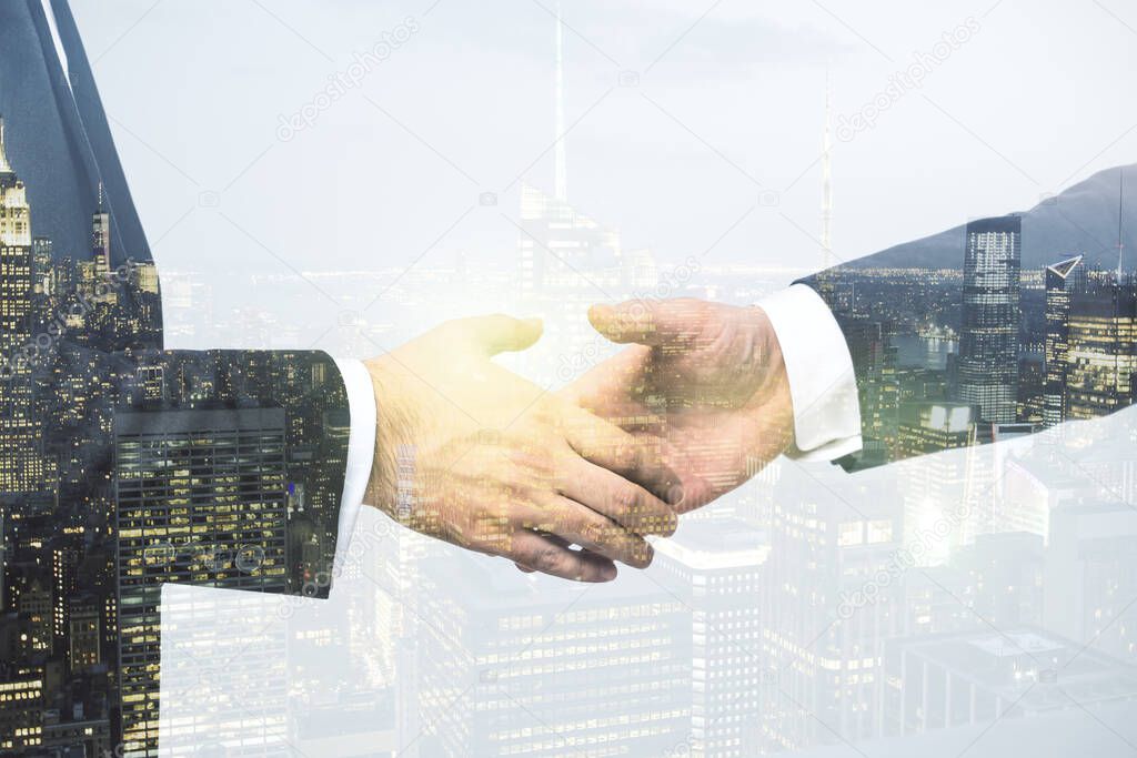 Double exposure handshake of two businessmen on office buildings background, collaboration and cooperation concept