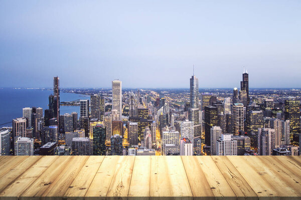 Table top made of wooden dies with Chicago city view at dusk on background, template