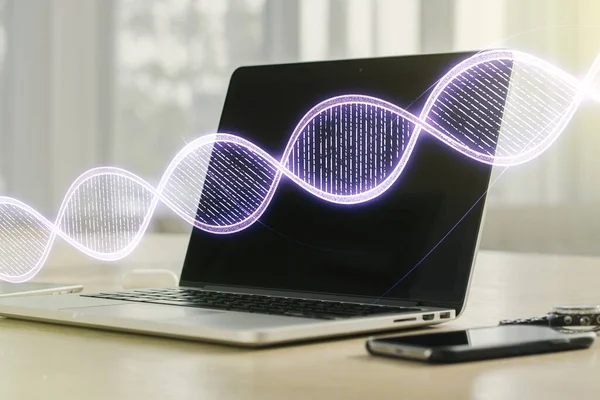 Double exposure of creative DNA hologram on laptop background. Bio Engineering and DNA Research concept