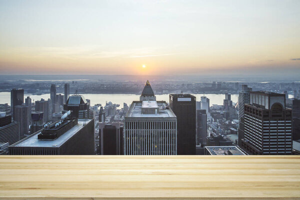 Blank wooden tabletop with beautiful New York skyline at daytime on background, mockup
