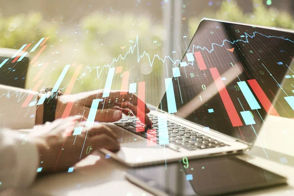 Creative concept of crisis chart illustration with hands typing on laptop on background. Global crisis and bankruptcy concept. Multiexposure