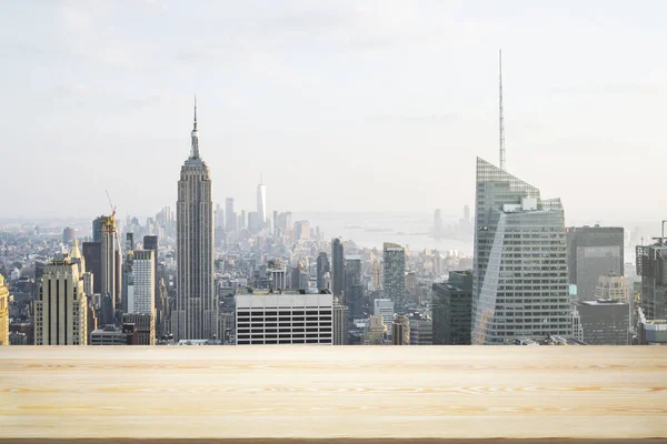 Mesa de madera en blanco con hermoso horizonte de Nueva York durante el día sobre fondo, maqueta — Foto de Stock