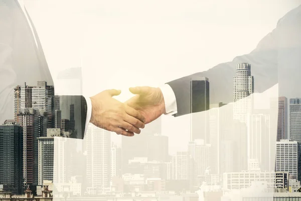 Multi exposure of handshake two businessmen on city skyline background, cooperation and coworking concept — Stock Photo, Image