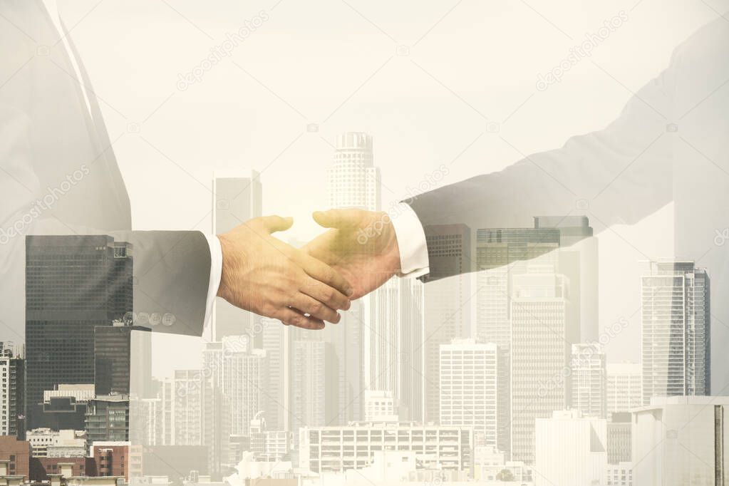 Multi exposure of handshake of two businessmen on city skyscrapers background, collaboration and teamwork concept