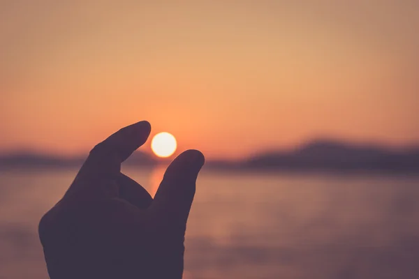 Silhouette of hand with sign on sun — Stock Photo, Image