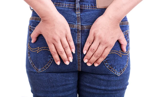 Woman's hand holding the backside : Concept hemorrhoids — Stock Photo, Image