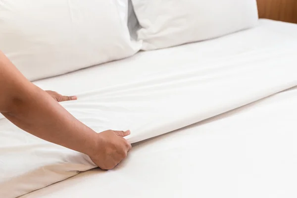 Mano establecer sábana blanca en la habitación de hotel —  Fotos de Stock