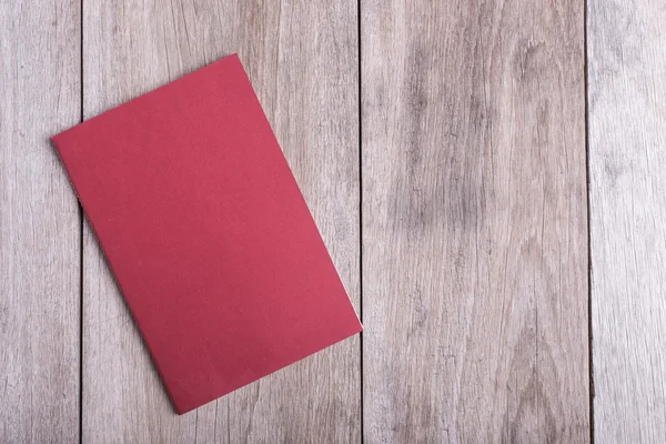 Top view of book on old wooden plank — Stock Photo, Image