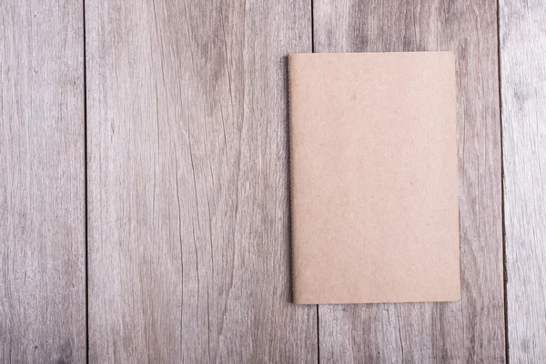 Top view of book on old wooden plank — Stock Photo, Image