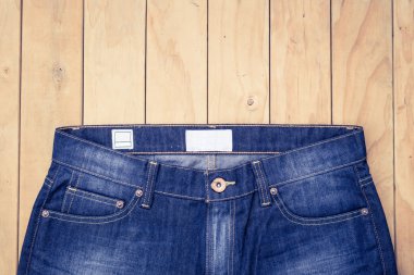 Mavi jeans ahşap arka plan üzerinde görünümü top