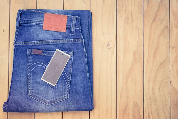 Blue jeans on wooden background top view — Stock Photo, Image