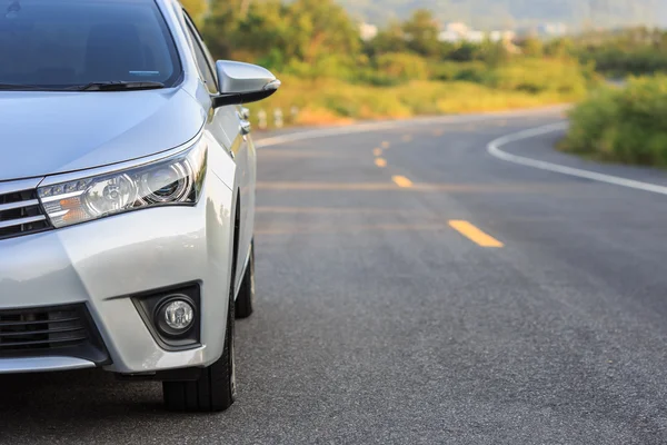 Front of new silver car parking on the asphalt road — Stock Photo, Image