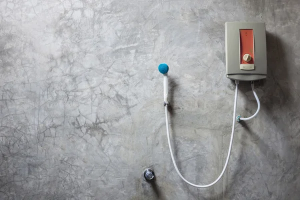 Water heater on the grey cement wall in bathroom — Stock Photo, Image