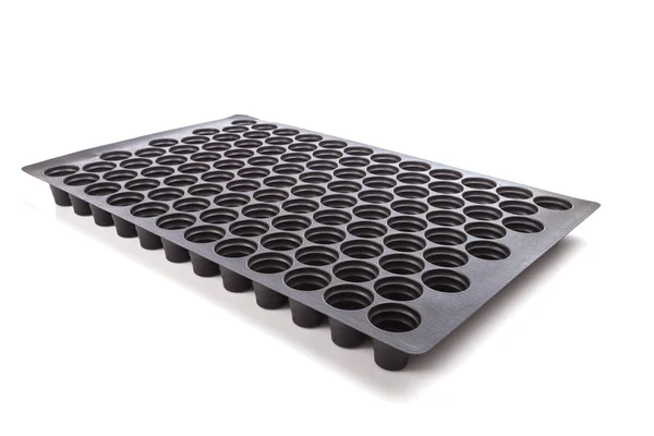 Black empty plastic tray with hole for seedlings isolated on whi — Stock Photo, Image