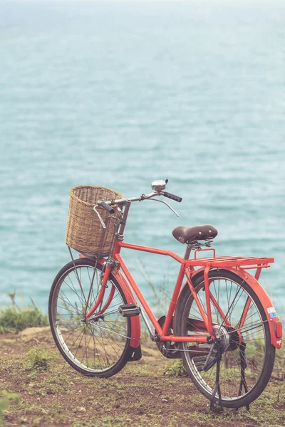 Red Japan style classic bicycle at ocean view point