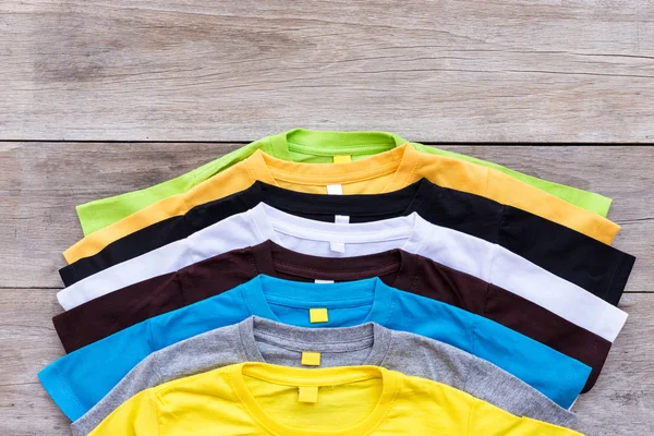 Felülnézet színes póló a fából készült deszka — Stock Fotó