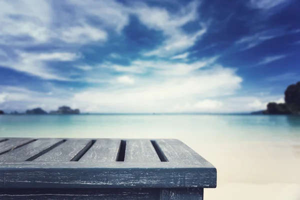 Empty top of wooden table and view of tropical beach background. Stock Picture