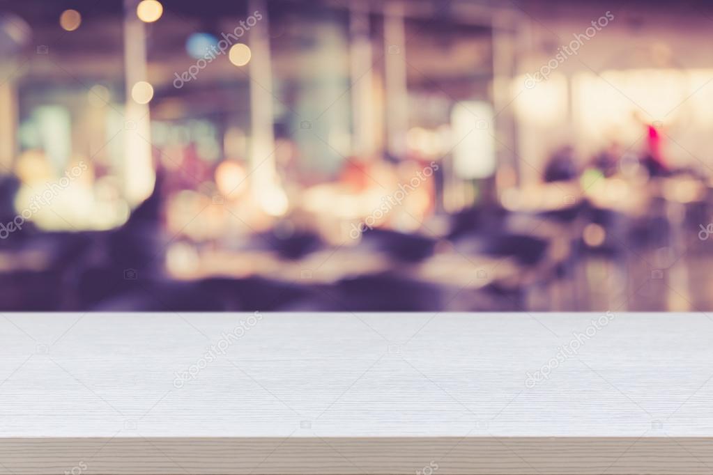 Empty top of wooden table or counter on blurred abstract backgro