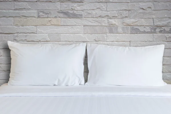 White bedding sheets and pillow in hotel room