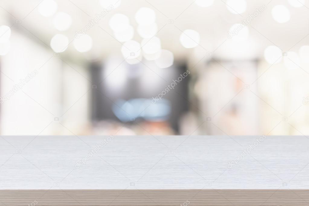 Empty top of wooden table or counter on blurred abstract backgro