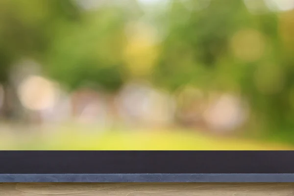 Empty top of granite stone table or counter on blurred green bac — Stock Photo, Image