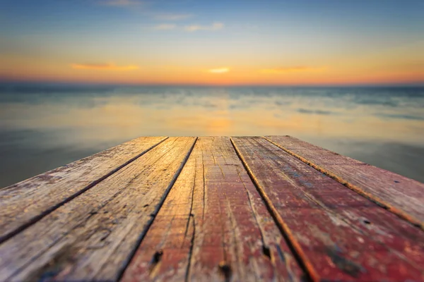 Haut de la vieille table en bois avec fond de coucher de soleil flou — Photo