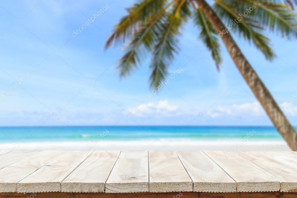 Empty top of wooden table or counter and view of tropical beach 