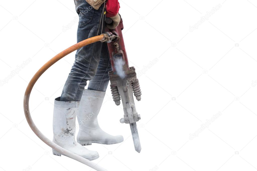 Construction worker removes excess concrete with drilling machin